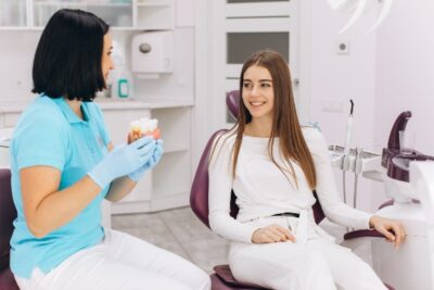 dentist talking to a female patient about dental crowns