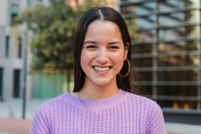 girl in a purple sweater smiling