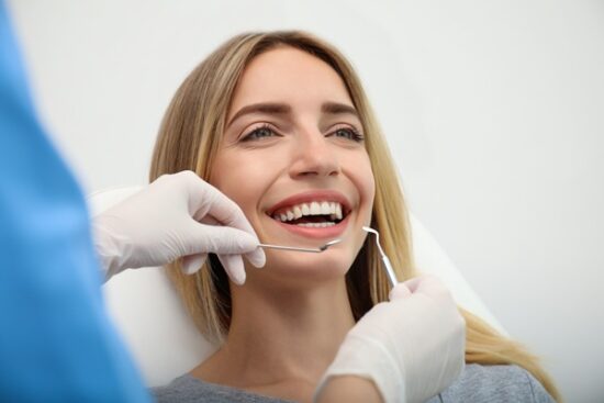 young woman smiling at the dentist's office