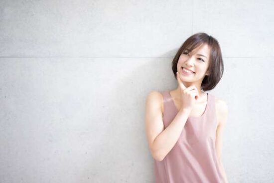 young woman in pink top smiling