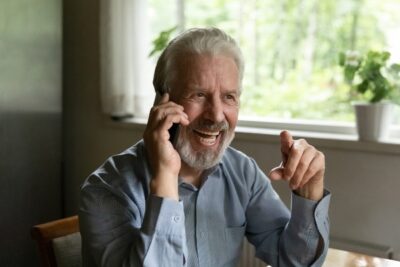 older man on the phone and smiling