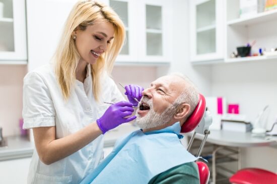 dentist cleaning a patient's teeth