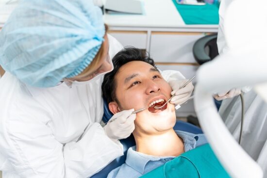 man undergoing a dental cleaning