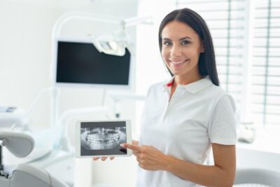 dental hygienist holding an X-ray