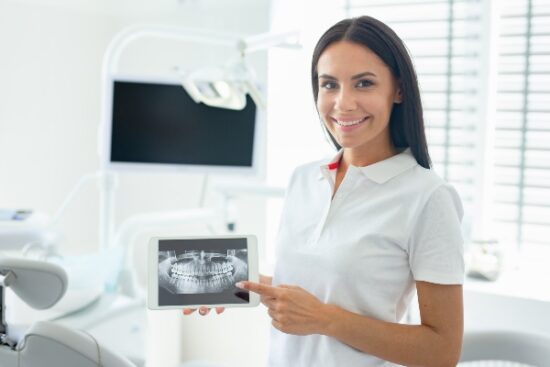 dental hygienist holding an X-ray