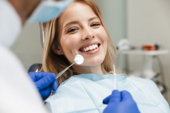 young woman smiling in the dentist's chair