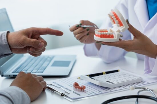 patient talking to dentist with a mouth mold