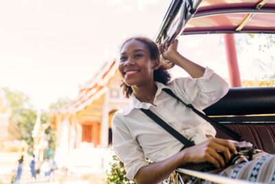 woman smiling and on an open tram