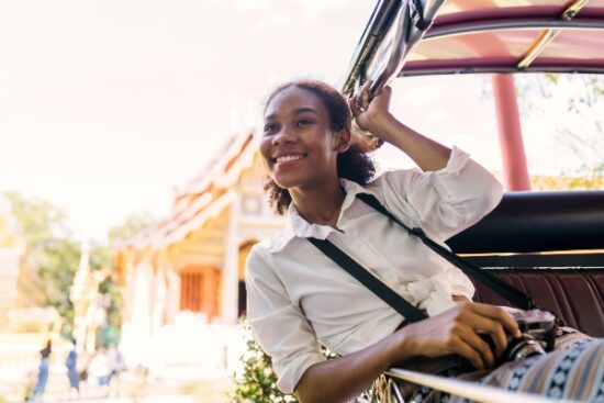 woman smiling and on an open tram