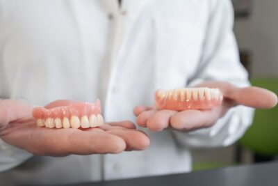 person holding full dentures