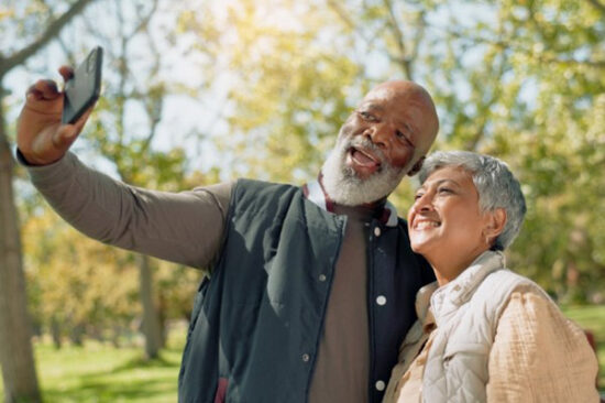 older couple smiling and taking a photo