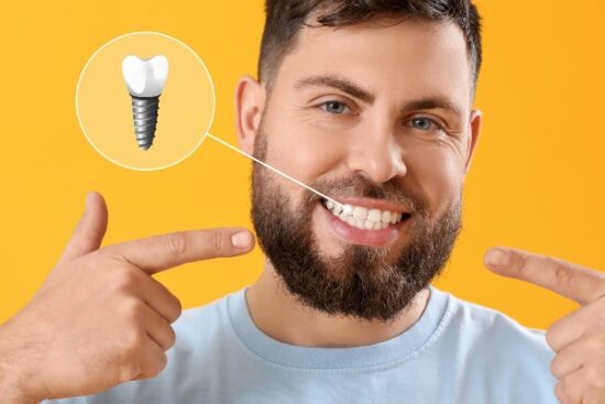 man with a beard pointing to his smile and single dental implant