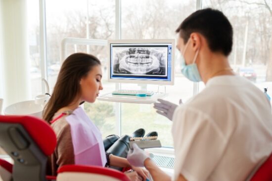 female patient listening to a dentist discuss dental implants