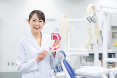 implant dentist holding mouth mold