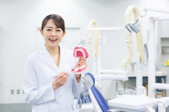 implant dentist holding mouth mold