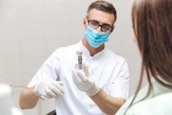 implant dentist talking with patient