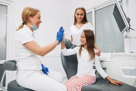 little girl giving the dentist a high-five