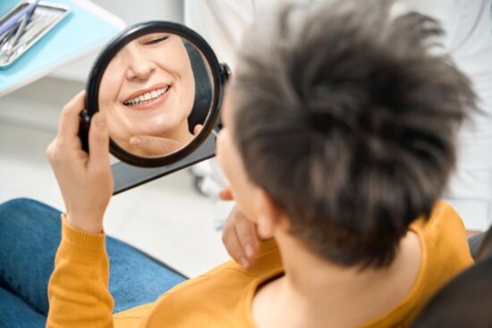 woman looking at herself in the mirror