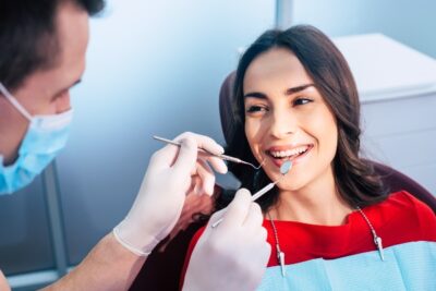 woman having her teeth checked by her dentist