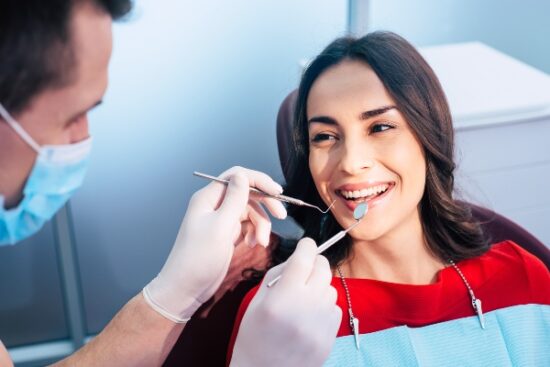 woman having her teeth checked by her dentist