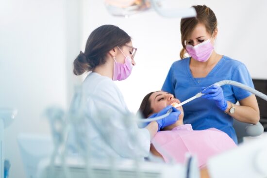 dental team working on a patient's mouth