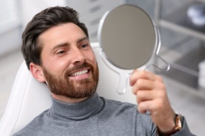 man with beard smiling with dental implants