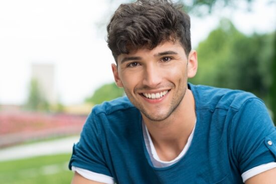 Young man in blue shirt smiling