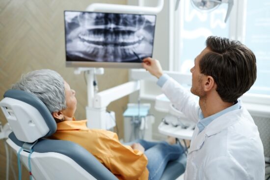 dentist showing patient their x-rays