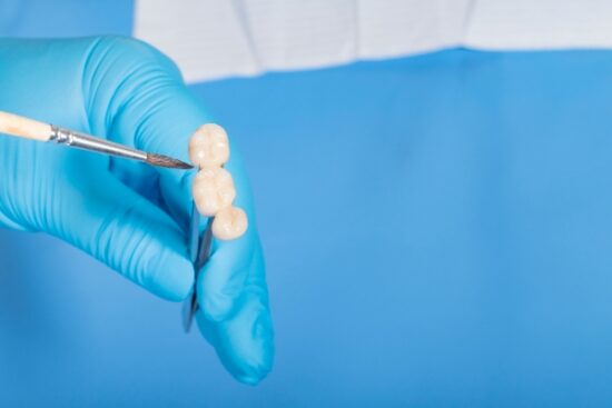dental instrument pointing to fixed bridge