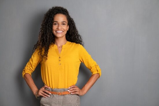 woman in a yellow blouse and smiling