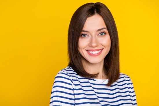 young woman smiling in a striped shirt